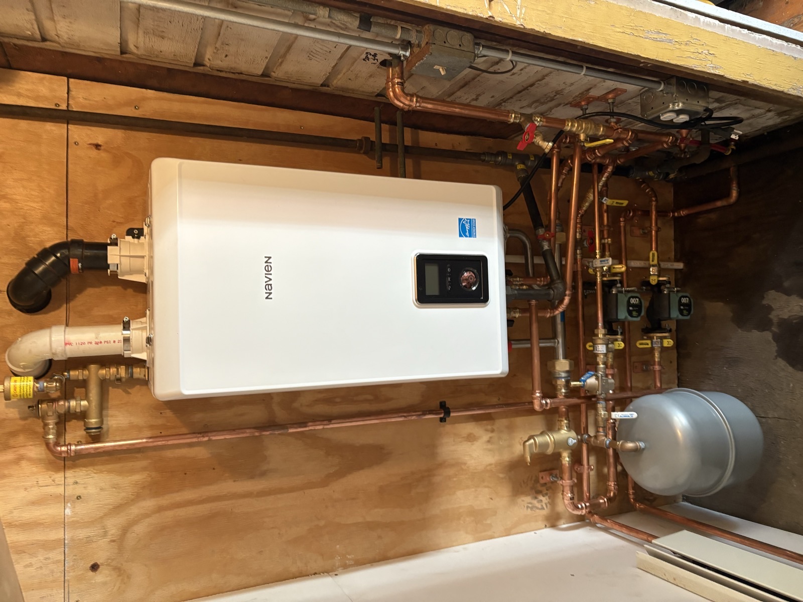 High-efficiency Navien boiler installation with copper manifold and circulator pumps